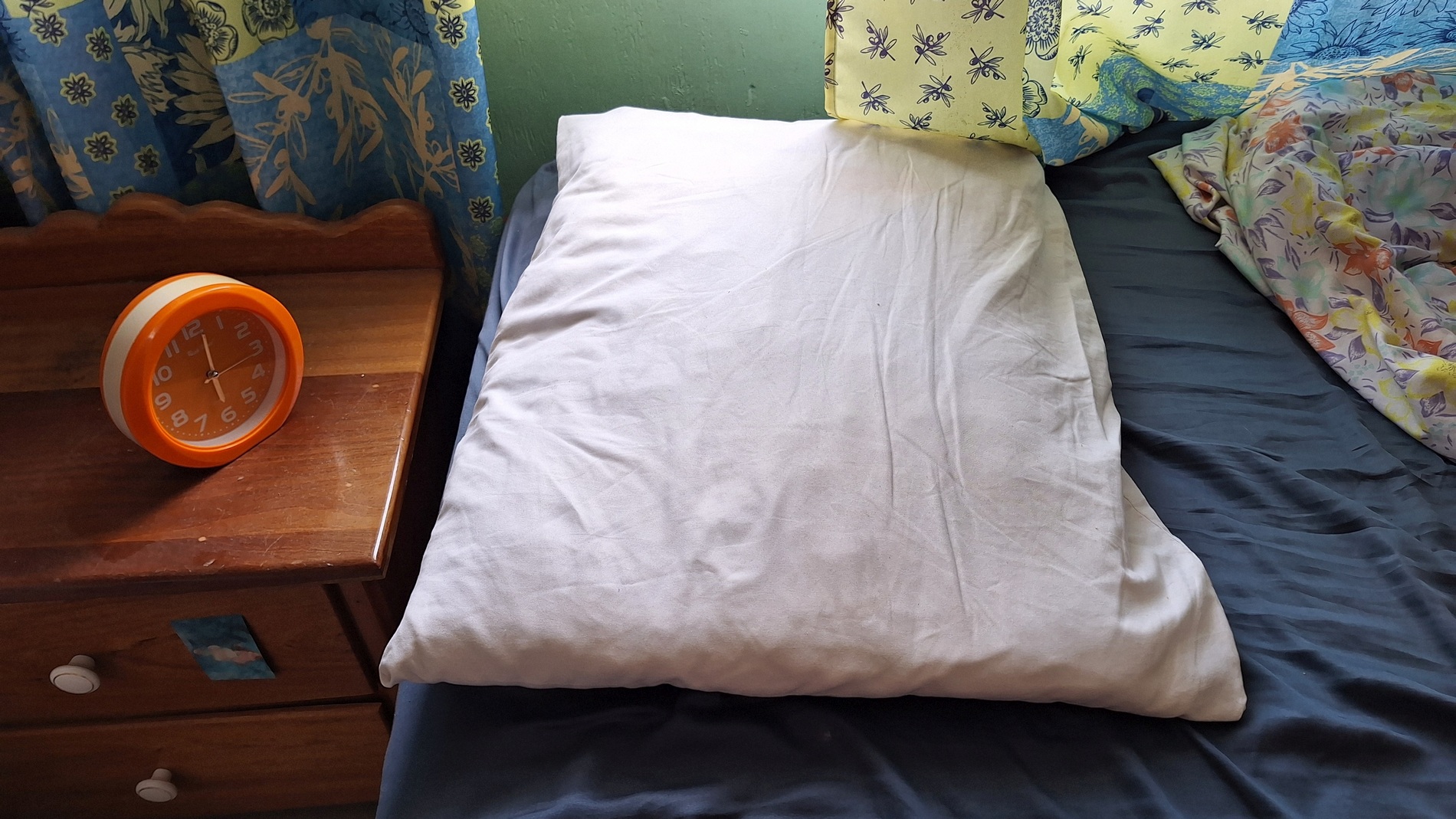 empty bed and alarm clock